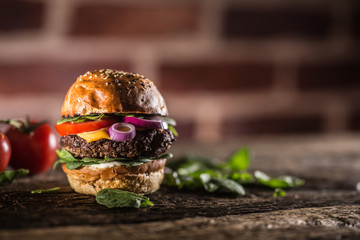 Canvas Print - Tasty beef burger with spinach leaves salad onion tomato and cheese