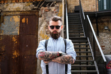 Portrait Of Bearded Man With Tattooes On His Arms