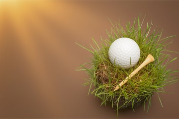 Wall Mural - Golf Ball in grass on white background. Sport and Recreation Concept