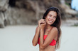 © romannoru - Portrait of sexy smiling traveler in colorful swimwear resting on sandy beach