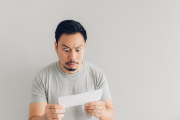 Man is shocked and surprised with the white mail message or the bill.