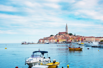 Wall Mural - beautiful city landscape with sea boats, colorful houses and an ancient tower in rovinj, croatia, eu