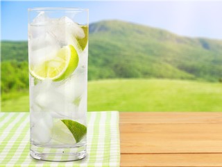 Sticker - Glass of water  and lime on  background