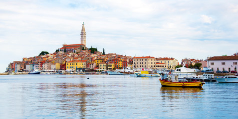 Wall Mural - beautiful city landscape with sea boats, colorful houses and an ancient tower in rovinj, croatia. po