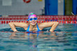 © afefelov68 - Portrait of a smiling woman swimmer in blue swimsuit in the pool after the completion of training.