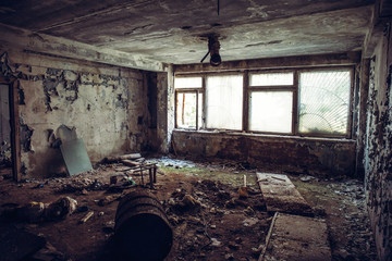 Abandoned ruined industrial building room inside interior, dark dirty grunge and creepy atmosphere