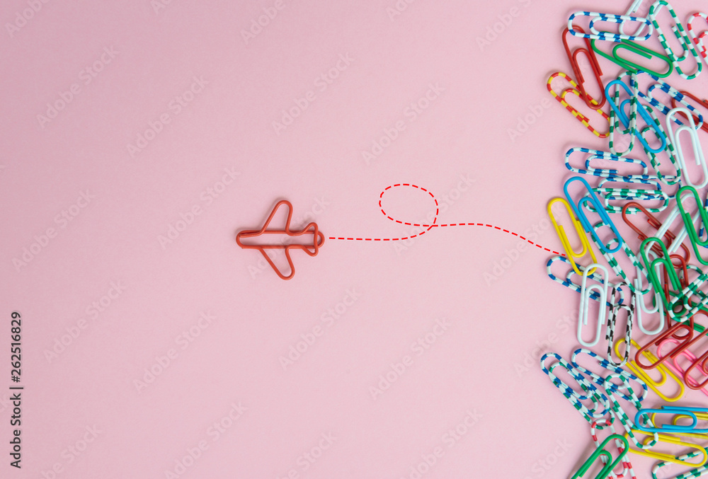 Business concept for group of stacked paperclip with another one red plane paperclip is point to another direction as a team leadership - obrazy, fototapety, plakaty 