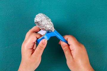 Diy cinco de mayo maracas from eggs, spoons and cereals on a green background.