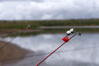 © baon - Fishing bell at the end of a fishing rod. Bells will ring when the fish is hooked .