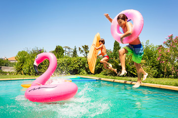 Happy friends enjoying pool party in summer