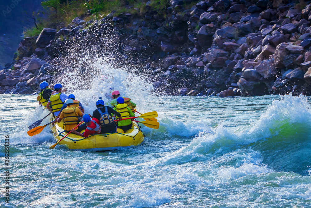 White water river rafting in Rishikesh, India. Sports activity by group of tourist. - obrazy, fototapety, plakaty 