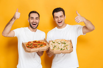 Poster - Image of two bearded men bachelors 30s in white t-shirts smiling and holding pizza boxes