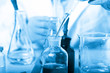 © onlyyouqj - Laboratory beaker in analyst's hand in plastic glove