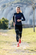 © nenetus - Sporty young woman running on mountain in beautiful nature.