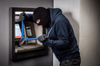 © kaninstudio - Thief with bolt cutter hacks an ATM. Law and crime concept