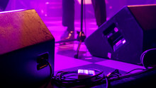 Stage Monitor Speakers And Cables In Purple Ambient Light At Band Live Gig