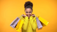 Excited Young Woman In Stylish Yellow Sweater Holding Shopping Bags, Discount