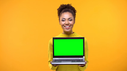 Beautiful woman holding green screen laptop, shopping online, bookmakers office