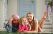 © okostia - Young happy family having fun in courtyard of the summer house