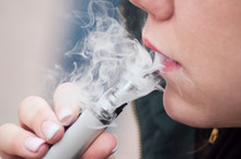 Closeup Of Mouth Of Woman With E-cigarette In Outdoor