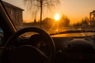 Wall Mural - driving a car on a hot summer sunny day. hands of the driver behind the wheel.