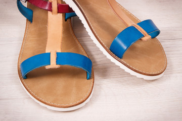 Pair of womanly leather sandals, footwear for holiday concept