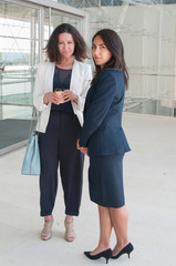 Canvas Print - Serious colleagues relaxing and looking at camera in office hall