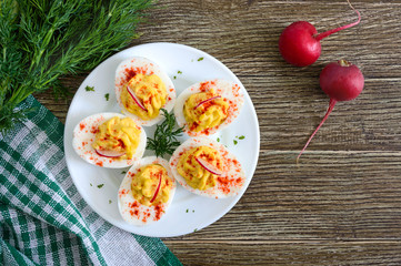 Deviled eggs. Delicious appetizer. Boiled eggs stuffed with yolk, mustard, mayonnaise, paprika. Classic recipe. The top view