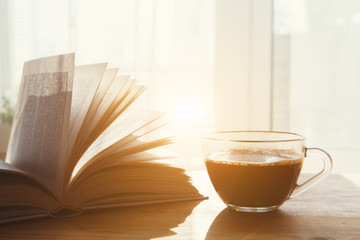 Wall Mural - cup on morning coffee and open book on wooden table