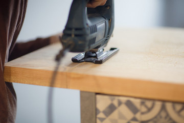 Carpenter working with circular saw. Home renovation