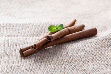 Cinnamon sticks and mint on burlap