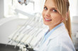 © gpointstudio - Portrait of smiling female dentist in dentist's office