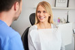 © gpointstudio - Portrait of smiling woman at the dentist's office