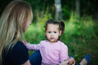 © olsima - Beautiful woman and her little daughter having fun in the meadow, single mother concept, copy space