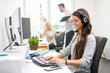 © Bojan - Friendly young customer support operator woman working in call center