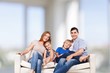 © BillionPhotos.com - Beautiful smiling family sitting at sofa at home