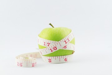 green apple and measuring tape