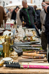 Flea market booth with many old items being sold.