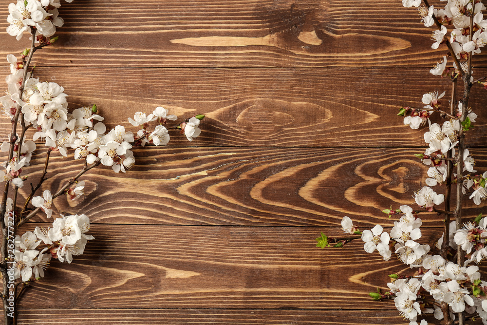 Beautiful blossoming branches on wooden background