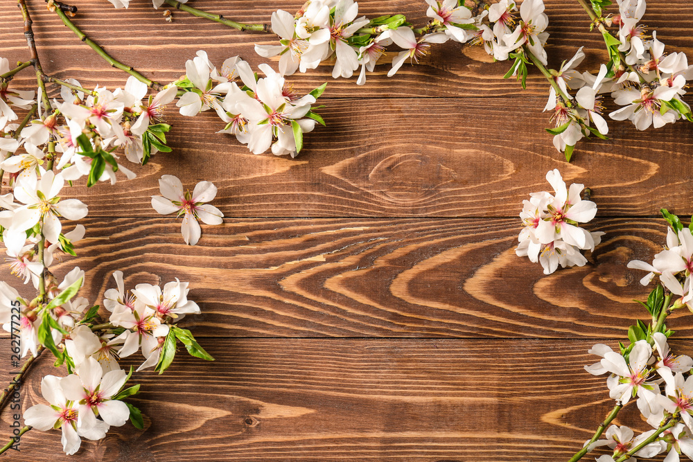 Beautiful blossoming branches on wooden background