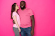 Waist up of happy interracial couple posing for camera in studio