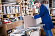 © JackF - Young male carpenter adjusting chipboard  indoors