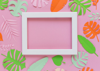 Wall Mural - White frame on a pink background with colored leaves