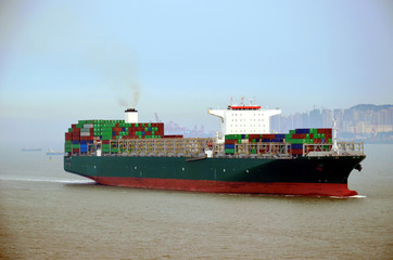 Container ship departing from port.