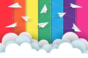 Many white paper planes fly on the background rainbow colorful while flying above a cloud. creative idea. illustration cartoon vector