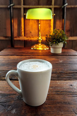 Coffee cup in wooden background