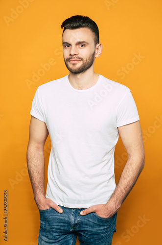 Stature And Well Built Man In Denim Jeans And White Basic T Shirt