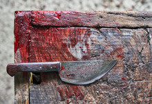 Knife With Blood On Wood Floor