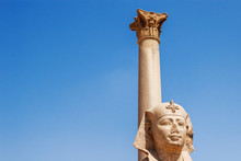 Pompey's Pillar, Roman Triumphal Column, With Two Sphinx Statues Located At The Serapeum Of Alexandria. Ancient Architectural Landmark In Egypt.