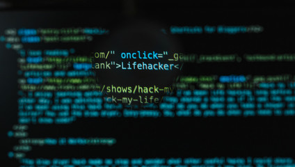 program code illustrative concept on display screen through magnifying glass